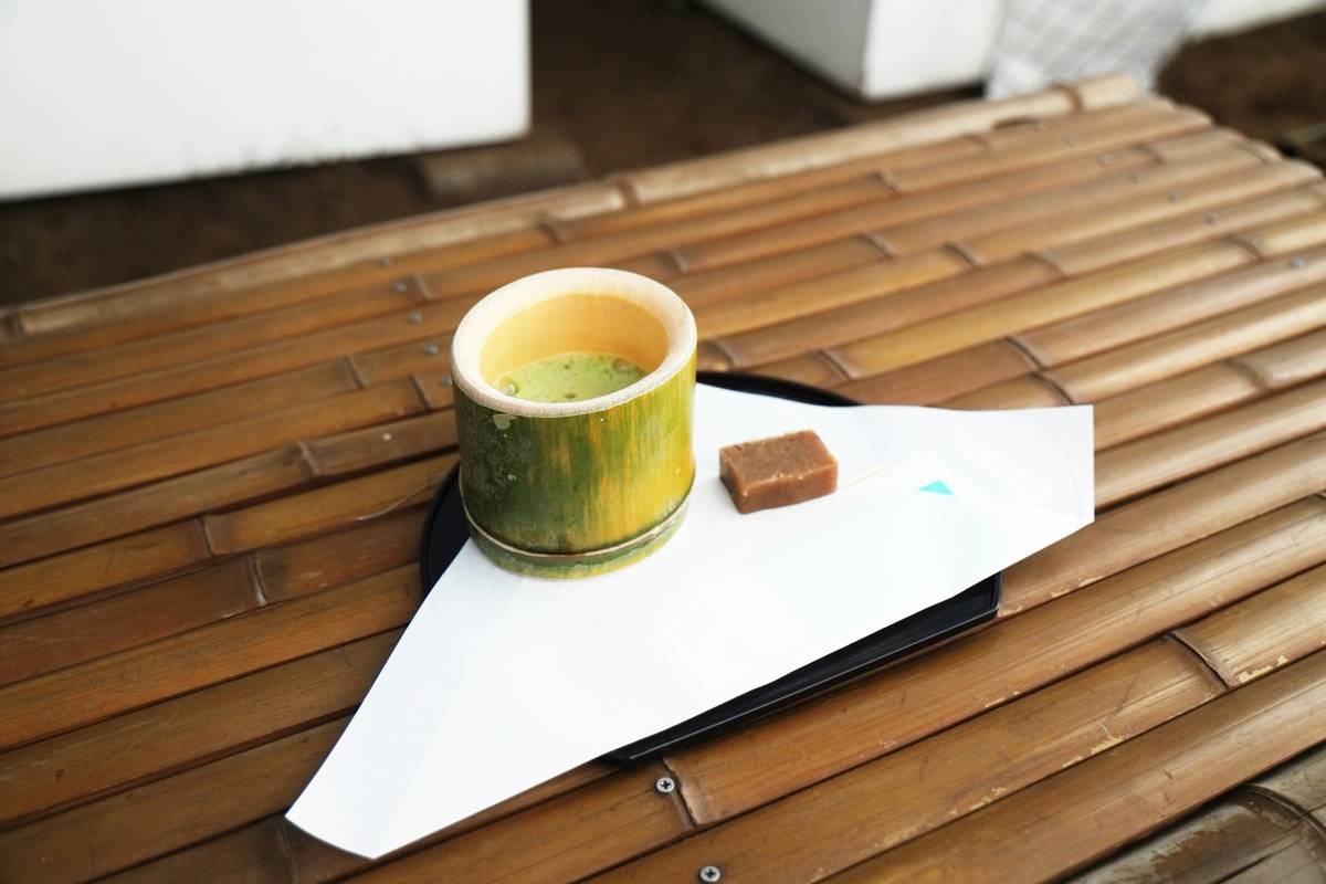 Wooden table with woven coasters and a fabric runner showing what to use instead of placemats